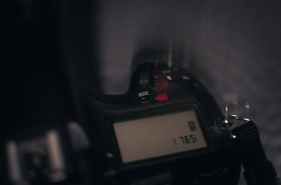 Close-up of a professional camera with flash firing