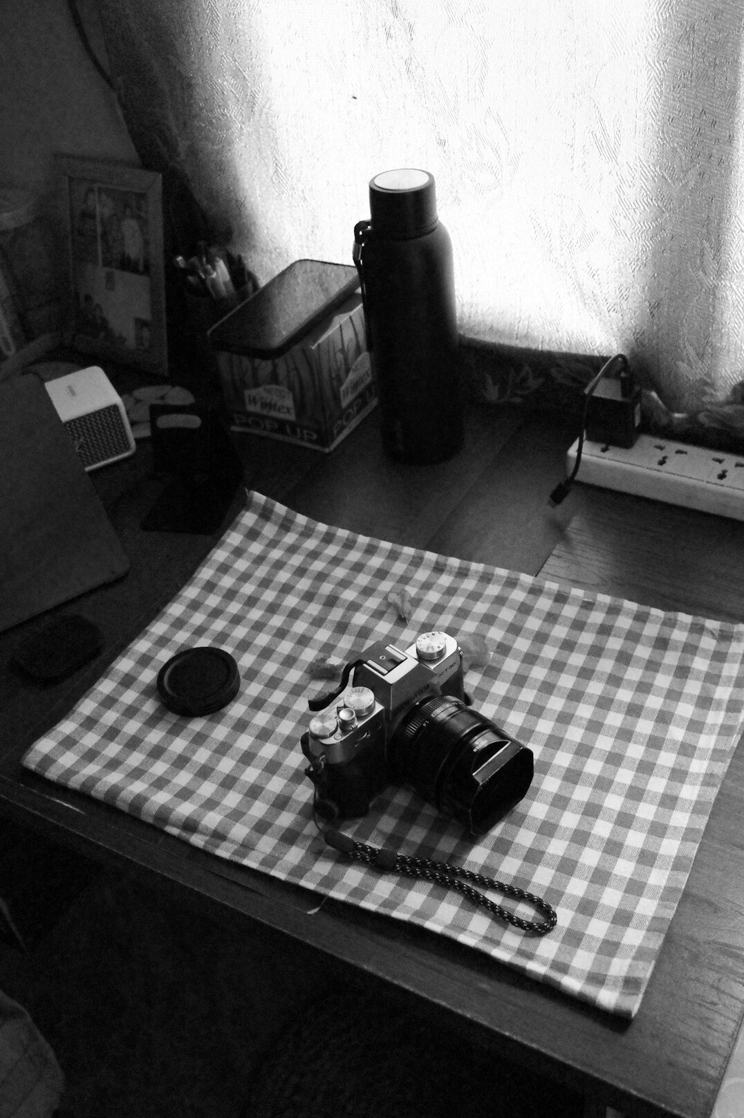 Reporter notebook, camera and coffee cup on an editorial desk